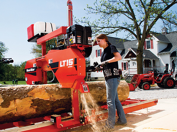 Feeding tree through portable saw mill