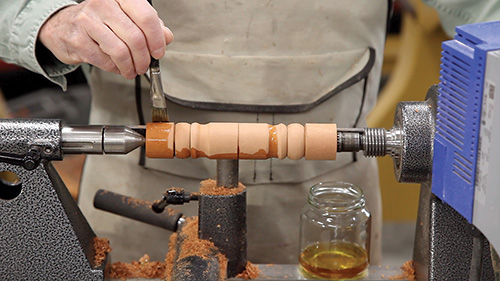 Brushing shellac finish onto a spindle turning