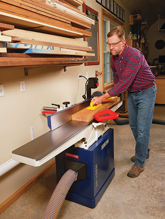 Cutting face of board on jointer using pushpads